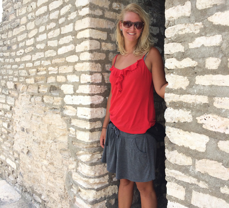 Cute American girl standing by some ancient ruins in Belize