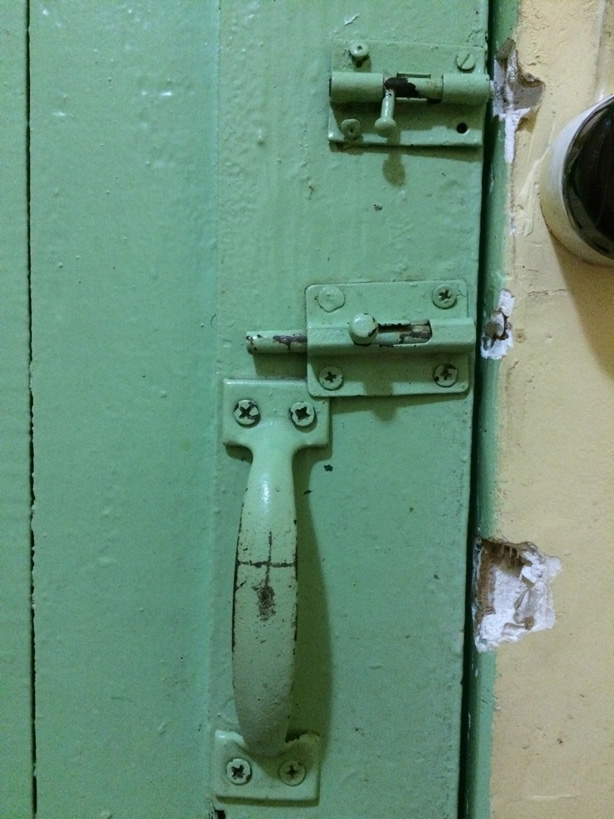 A door with broken locks in Belize